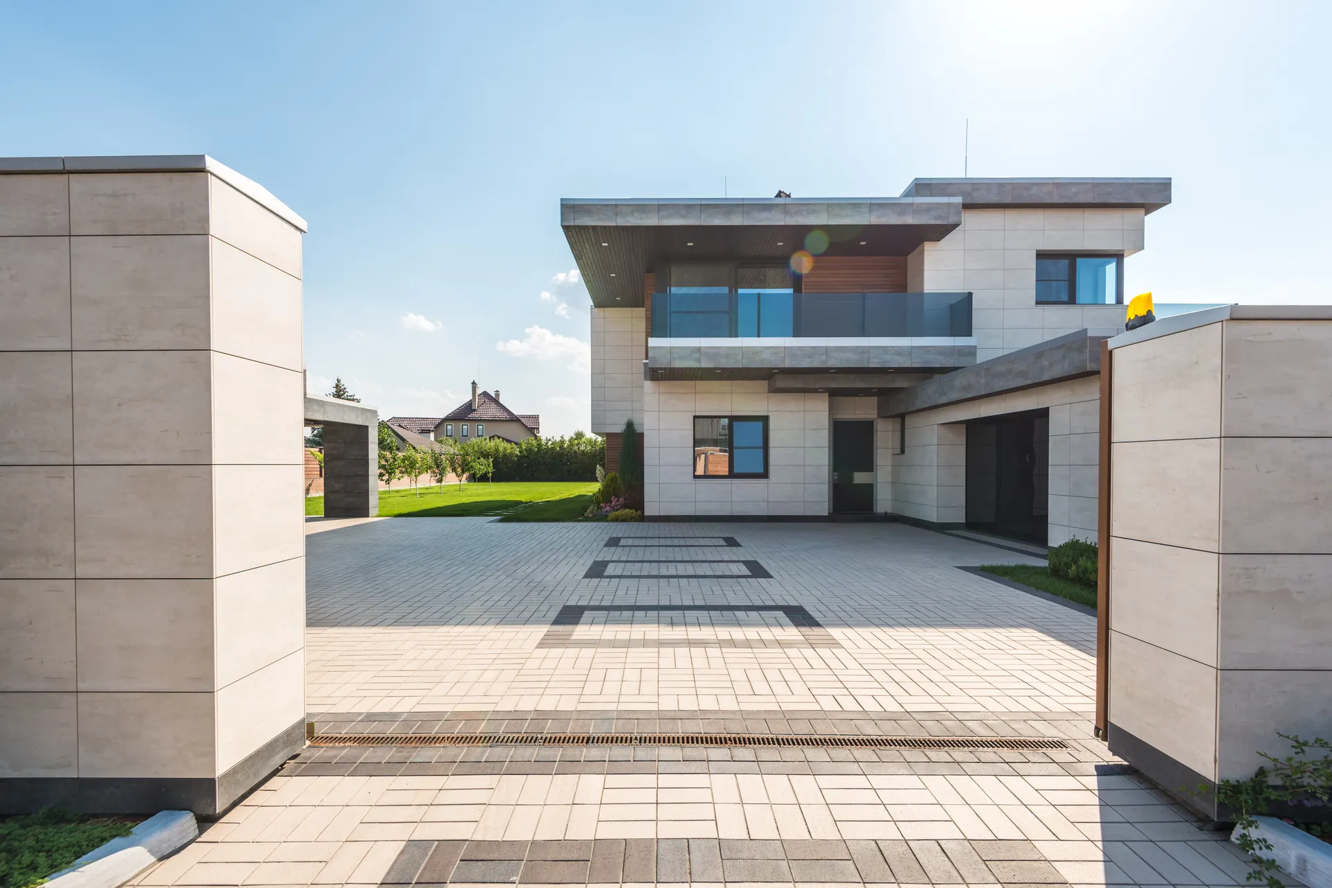 Contemporary building with a finely detailed stone facade and landscaped entrance